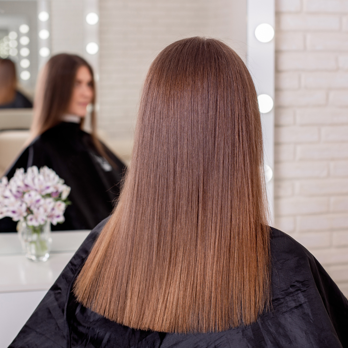 Female back with long straight brunette hair