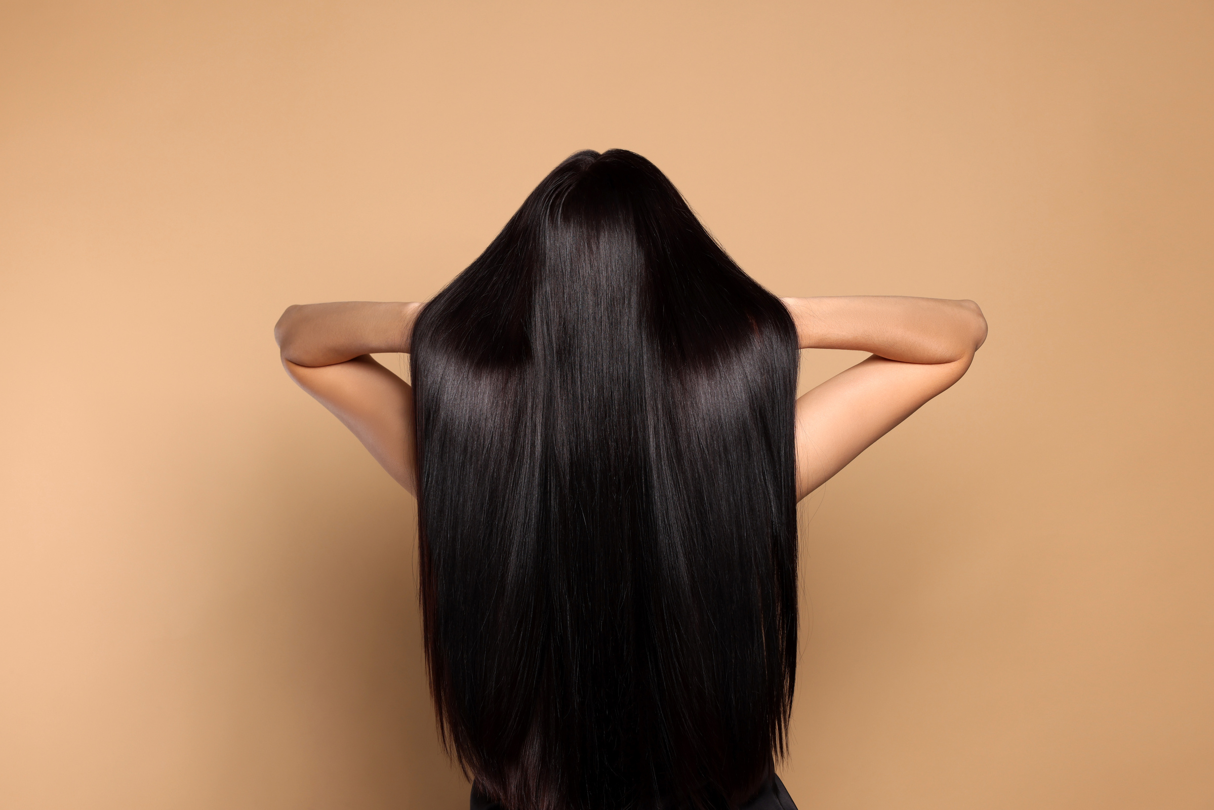 Woman with Strong Healthy Hair on Beige Background, Back View